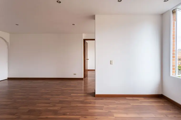 Wood-look laminate floor in an empty room with white walls