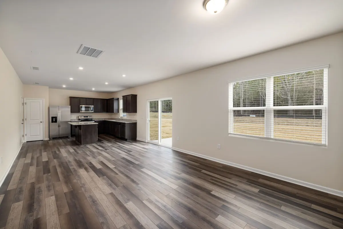 Wood-look laminate flooring through an open kitchen and living room