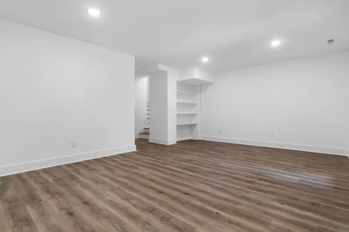 Gray luxury vinyl plank flooring in a bright empty room