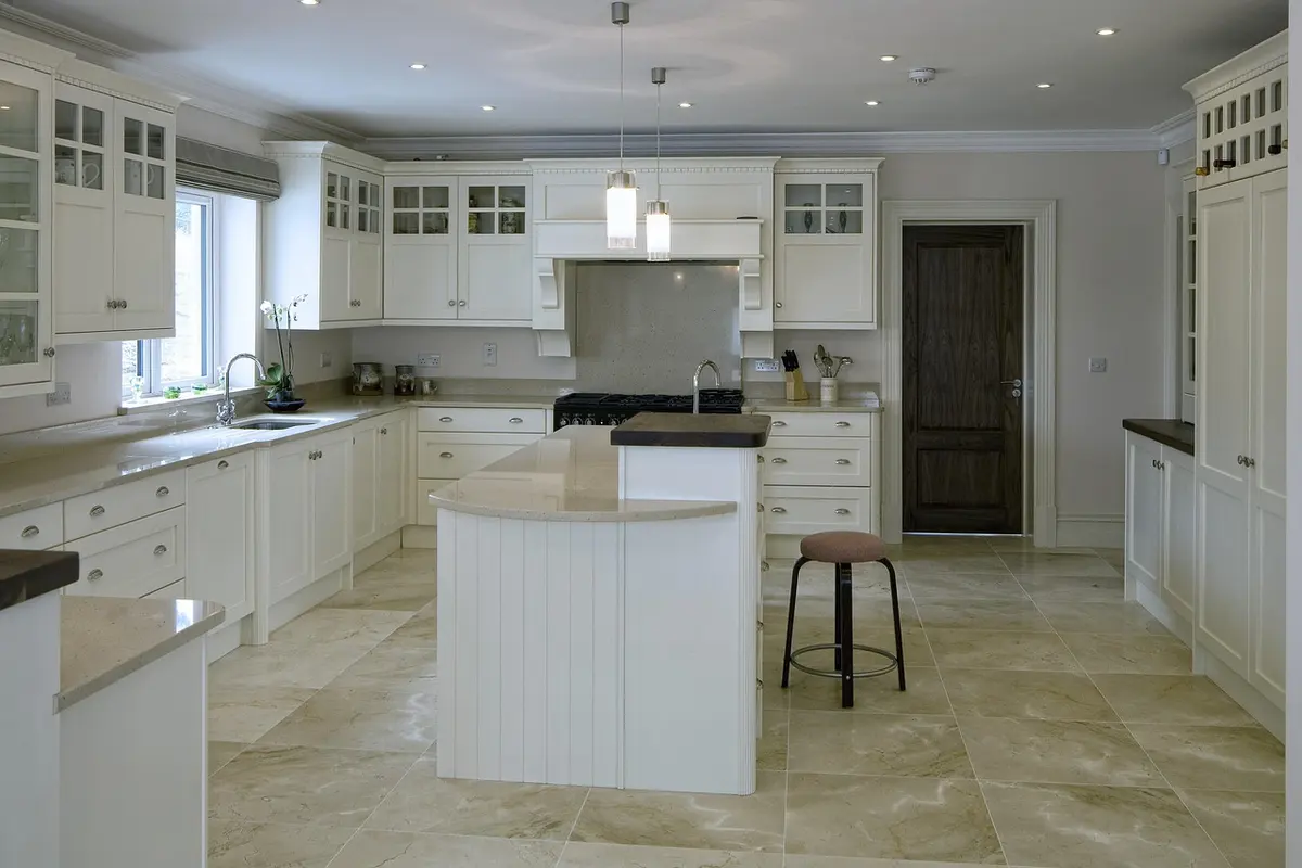 Large-format tile floor in a white kitchen