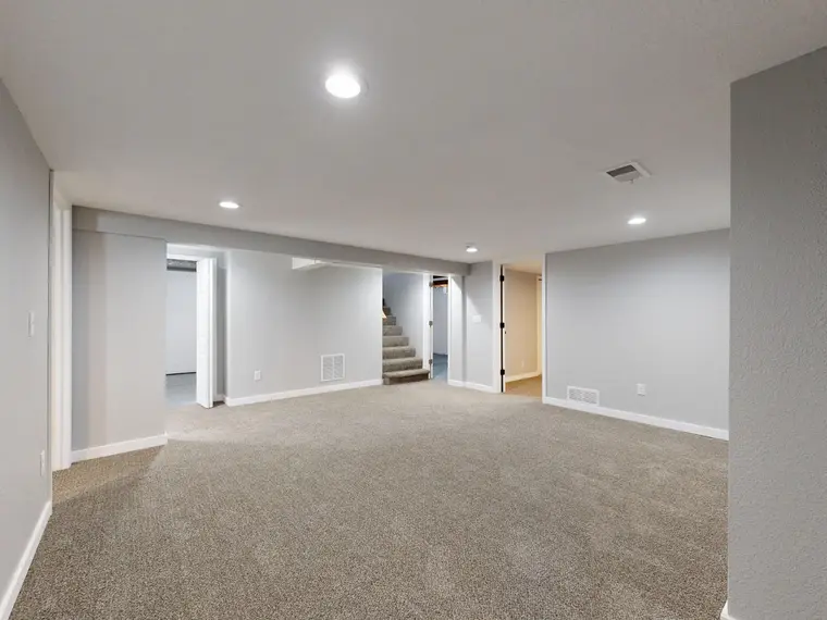 Spacious carpet flooring in a basement
